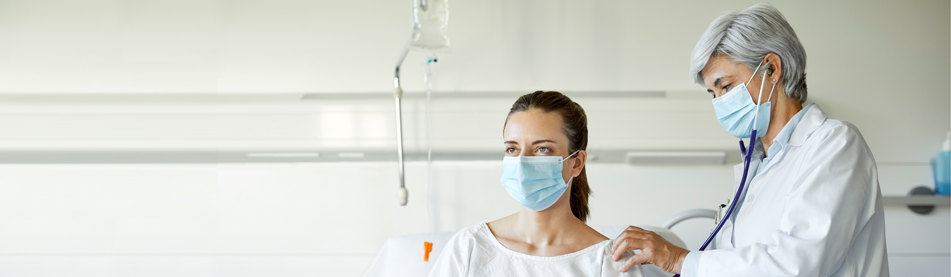Doctor using stethoscope on patient