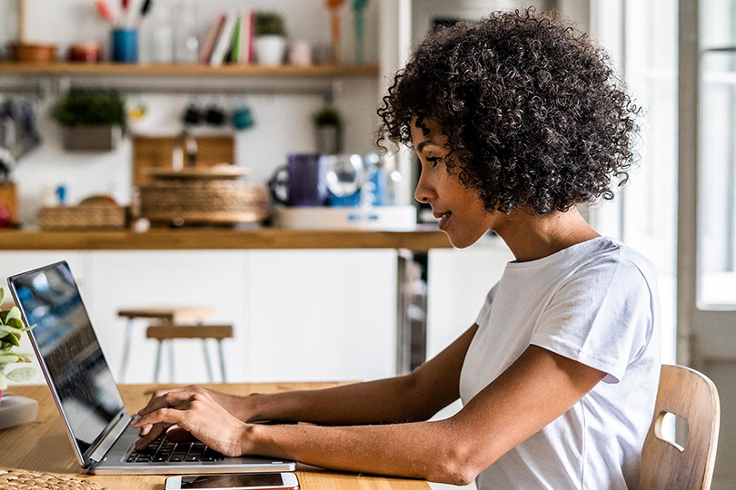 Young woman using laptop to access patient portal